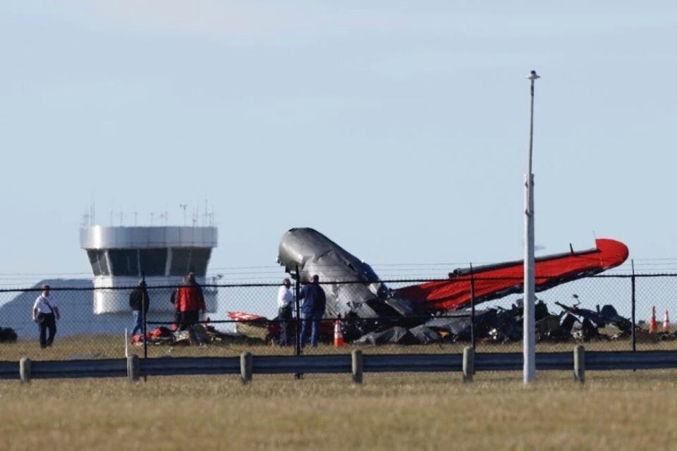 A damaged plane sits at the Dallas Executive Airport in Dallas after two historic military planes collided and crashed on Saturday, Nov. 12, 2022.