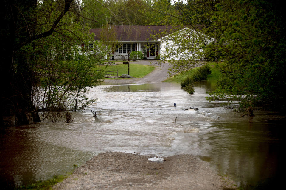 Water engulfs a Swan Township driveway at the intersection of Trimm and Roosevelt roads as heavy rains flood Saginaw County, Mich., on Tuesday, May 19, 2020. (Jake May/The Flint Journal via AP)