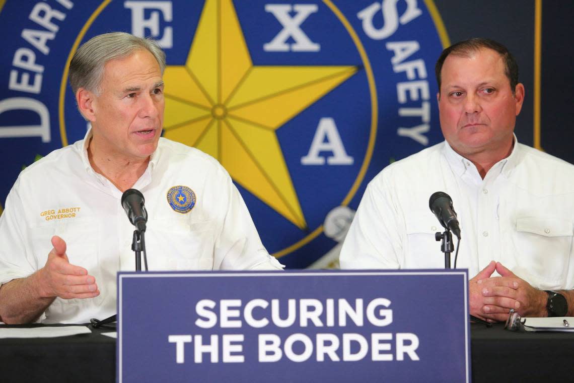 Texas Gov. Greg Abbott, left, speaks as Texas border czar Mike Banks listens during a news conference concerning border security at the Weslaco DPS Headquarters on Feb. 21. (Joel Martinez/The Monitor via AP)