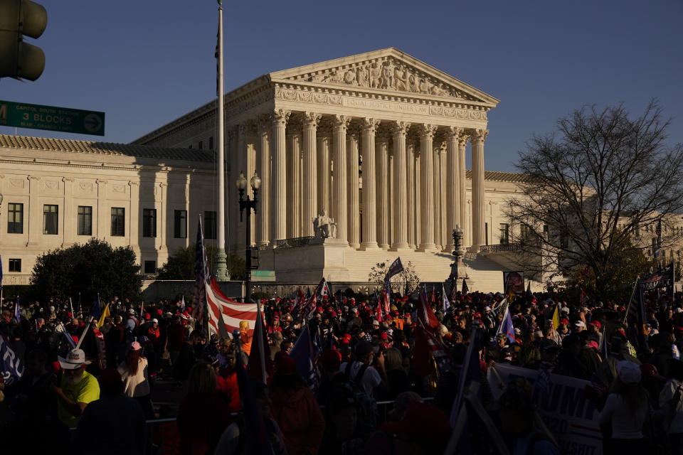 FILE - In this Nov. 14., 2020, file photo supporters of President Donald Trump attend pro-Trump marches outside the Supreme Court Building in Washington. The Supreme Court is hearing arguments over whether the Trump administration can exclude people in the country illegally from the count used for divvying up congressional seats. (AP Photo/Jacquelyn Martin, File)