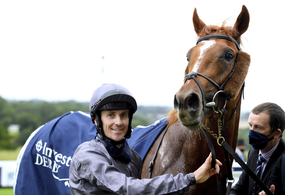 Jockey Emmet McNamara celebrates with Serpentine after winning the Investec Derby at Epsom Racecourse, in Epsom, England, Saturday, July 4, 2020. (Edward Whitaker/PA via AP)