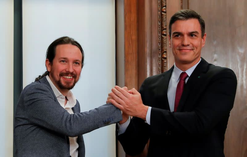 FILE PHOTO: Spain's acting PM Sanchez and Unidas Podemos leader Iglesias present their coalition agreement in Madrid