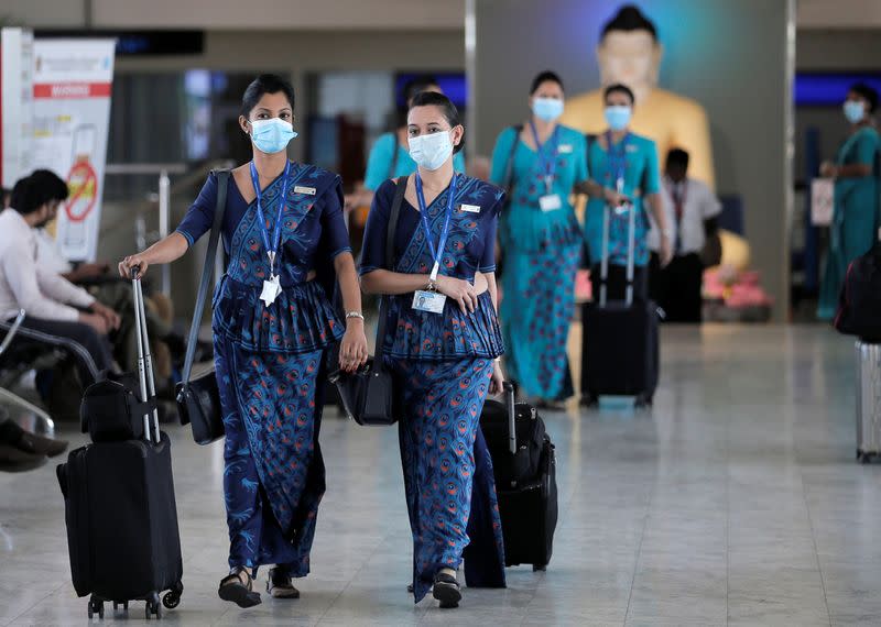 Sri Lankan Airlines staff wear masks at Bandaranaike International Airport after Sri Lanka confirmed the first case of coronavirus in the country, in Katunayake