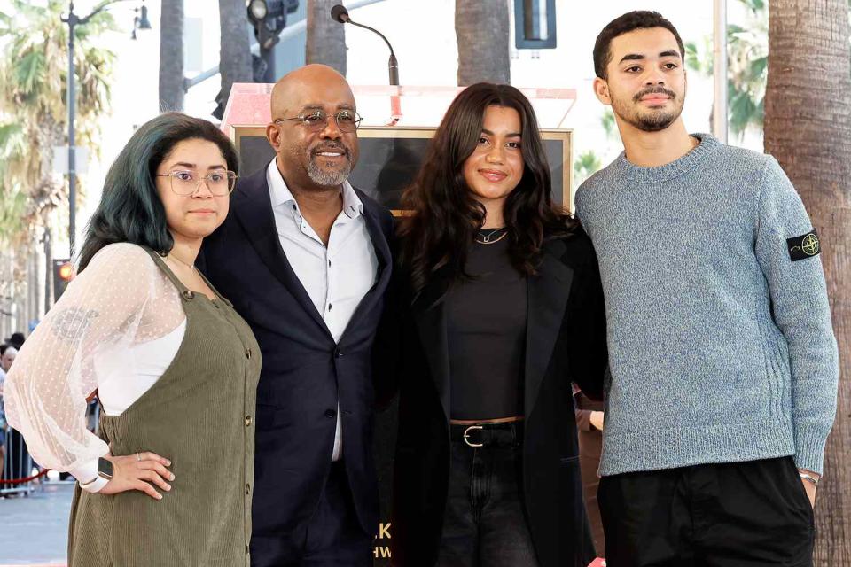 <p>Kevin Winter/Getty</p> Daris Rucker poses with all three of his kids at his Hollywood Walk of Fame ceremony