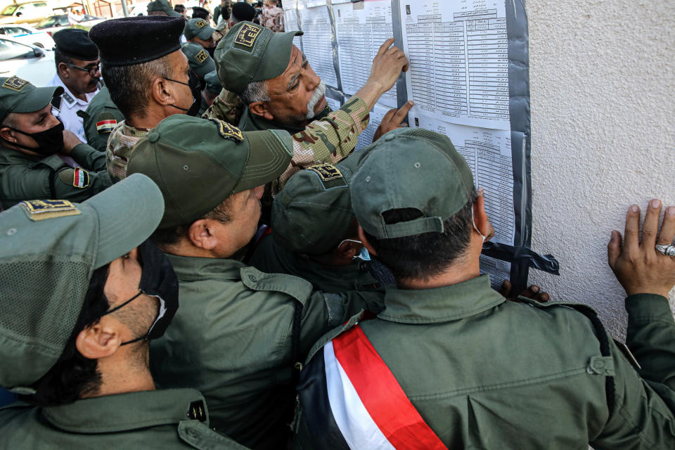 Security forces gather to vote during the early voting for security forces ahead of Sunday's parliamentary election in Basra, Iraq, Friday, Oct. 8, 2021. Iraqi security personnel across the country are casting their ballots Friday two days ahead of parliamentary election. (AP Photo/Nabil al-Jurani)