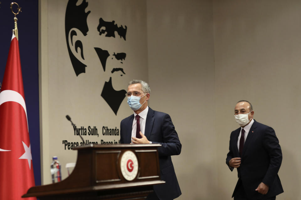 NATO Secretary-General Jens Stoltenberg, left, and Turkey's Foreign Minister Mevlut Cavusoglu arrive for a joint press conference after their talks in Ankara, Turkey, Monday, Oct. 5, 2020. Stoltenberg said the 30-country military alliance is "deeply concerned by the escalation of hostilities " between Azerbaijan and Armenia and he urged Turkey to help end the fighting. (AP Photo/Burhan Ozbilici)