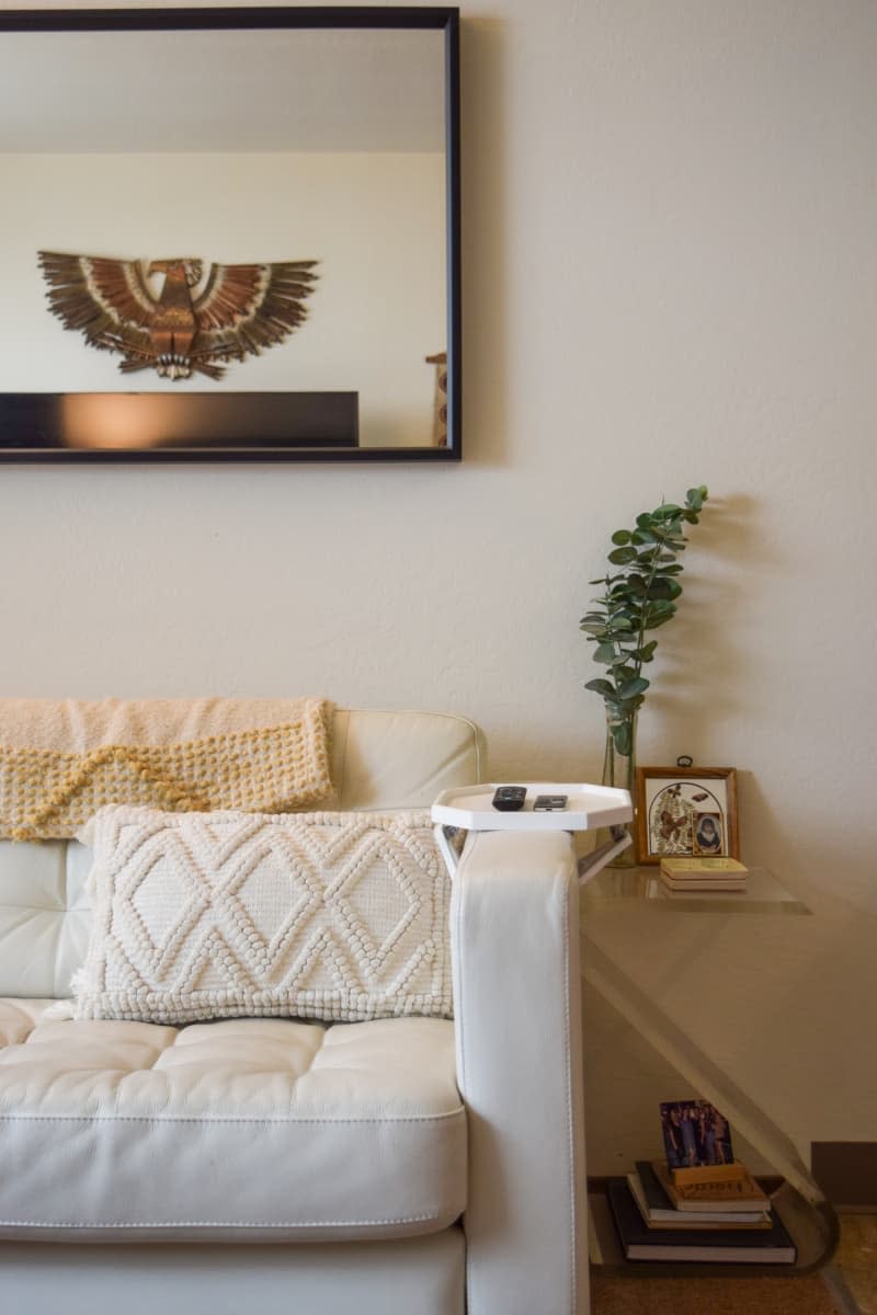 Living Room with decorative side table below-framed artwork.