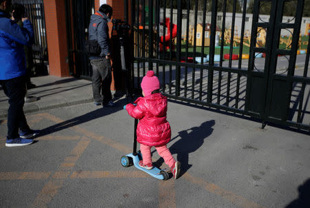 A child plays outside the kindergarten run by pre-school operator RYB Education Inc being investigated by China's police, in Beijing, China November 24, 2017. REUTERS/Jason Lee