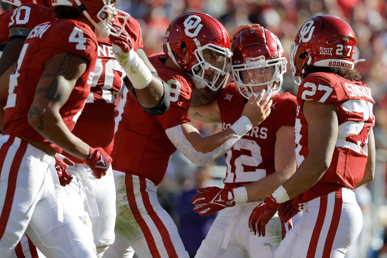 Oklahoma Sooners wide receiver Drake Stoops (12) celebrates with quarterback Dillon Gabriel (8) after catching a pass for a touchdown during a college football game between the University of Oklahoma Sooners (OU) and the TCU Horned Frogs at Gaylord Family-Oklahoma Memorial Stadium in Norman, Okla., Friday, Nov. 24, 2023. Oklahoma won 69-45.