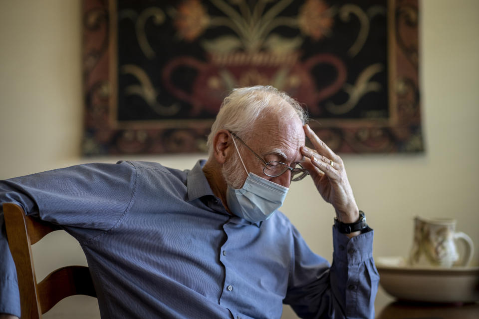 Jim Carpenter sits in the dining room of his home during an interview in Frederick, Md., Tuesday, Jan. 19, 2021, the day before the presidential inauguration. As a member of Braver Angels, Carpenter, who cheers Biden as the rightful winner, meets regularly with neighbor Natalie Abbas, who believes the election was stolen, to ponder the greatest challenge facing Biden and American society: how can they find common ground if they no longer exist in the same reality? (AP Photo/Cliff Owen)