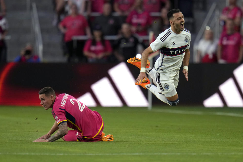Vancouver Whitecaps' Luis Martins, right, is yells after colliding with St. Louis City's Jake Nerwinski, left, during the first half of an MLS soccer match Saturday, May 27, 2023, in St. Louis. (AP Photo/Jeff Roberson)