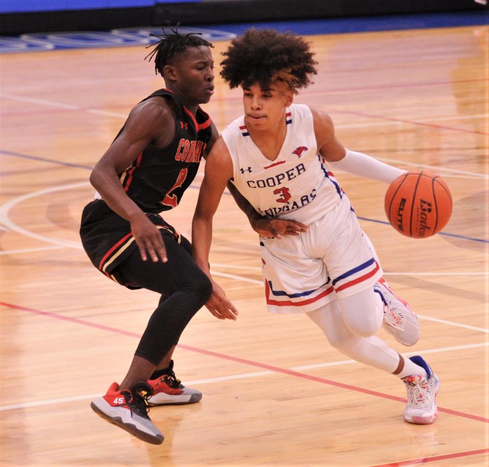 Cooper's Jordan Willis, right, drives past Lubbock Coronado's Ty Green in the first half.