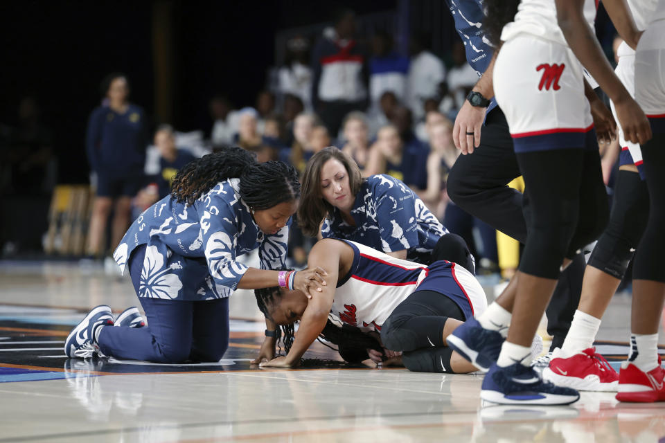 Mississippi head coach Yolett McPhee-McCuin, left, talks to Mississippi player KK Deans during the first half of an NCAA college basketball game against Michigan in the Battle 4 Atlantis at Paradise Island, Bahamas, Monday, Nov. 20, 2023. (Tim Aylen/Bahamas Visual Services via AP)