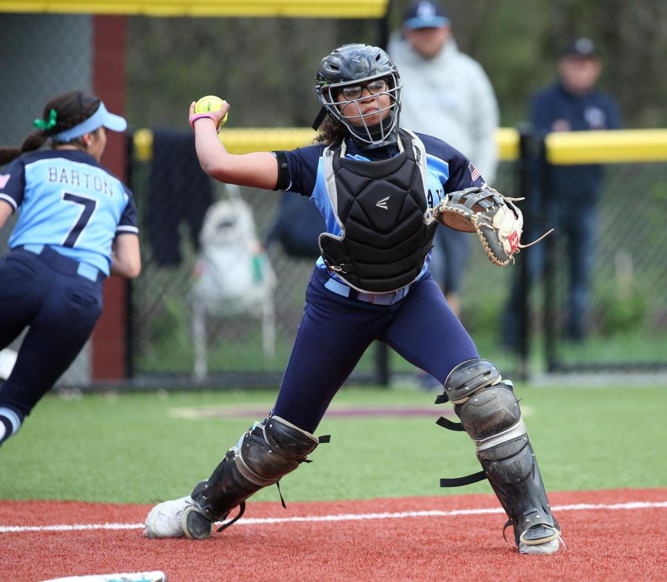 John Jay catcher Arielle Reddick sets for a throw to first during an April 17, 2023 softball game against Arlington.