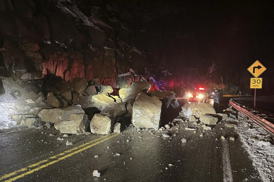 In this photo provided by the California Highway Patrol, fallen boulders from Echo Summit block U.S. Highway 50 in El Dorado County, Calif., early Wednesday, Dec. 20, 2023. The roadway was closed for three hours following the rockslide. (California Highway Patrol via AP)