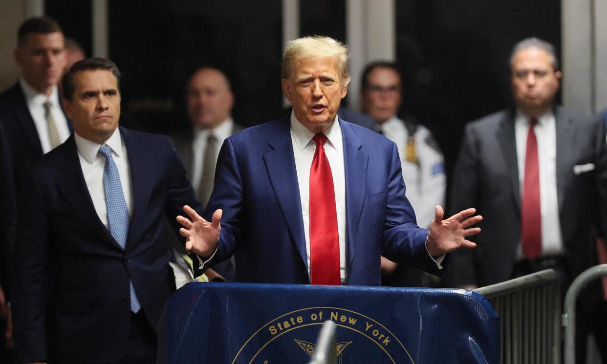 <span>Donald Trump speaks to the press at the end of a hearing to determine the date of his hush-money trial in New York on 25 March 2024. </span><span>Photograph: Brendan McDermid/AFP/Getty Images</span>