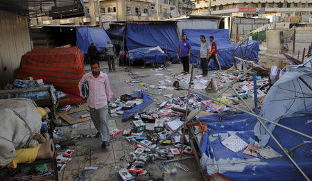 A man walks past the site of car bomb in New Baghdad, July 22, 2015. REUTERS/Khalid al-Mousily