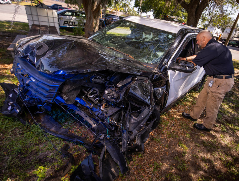 Ocala Police Sgt. Ron Malone looks into the Ocala Police unit he was driving in August 2023 when he was struck by a fleeing vehicle.