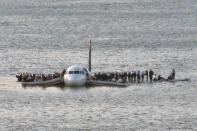 <p>In a memorable image from the day, passengers exited the plane and stood on the wings and inflatable rafts, waiting for rescue. </p>