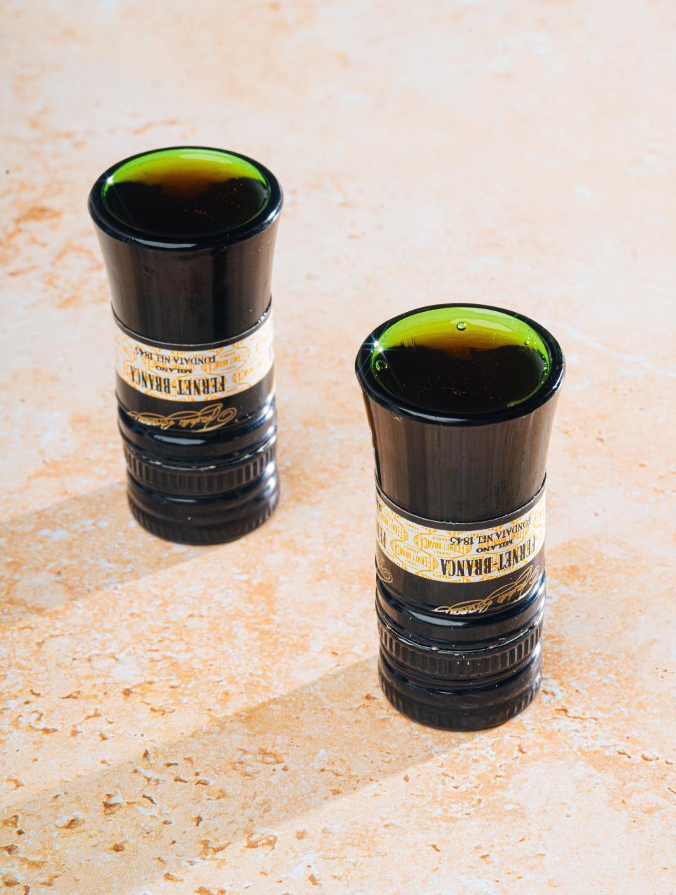 Fernet Branca and the Fernet Menta are combined to create the “bartender’s handshake.”  It is served in shot glasses sustainably made from the tops of old bottles at the Woodside Bistro at the historic, renovated Woodside Mill in West Greenville.