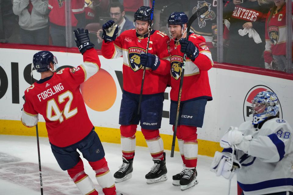 Apr 29, 2024; Sunrise, Florida, USA; Florida Panthers center Aleksander Barkov (16) celebrates a short-handed goal with center Sam Reinhart (13) and defenseman Gustav Forsling (42) against the Tampa Bay Lightning during the second period in game five of the first round of the 2024 Stanley Cup Playoffs at Amerant Bank Arena. Mandatory Credit: Jim Rassol-USA TODAY Sports