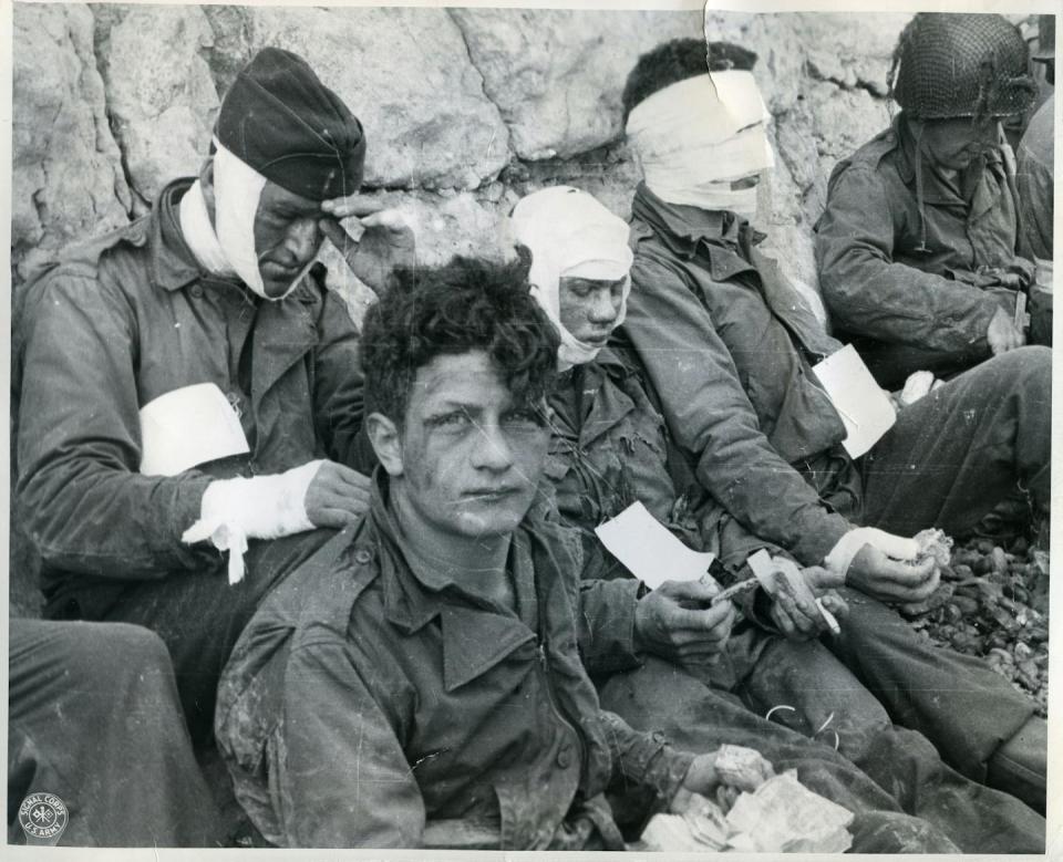 Wounded members of the 16th Infantry Regiment wait for evacuation from the beach on D-Day. <a href="https://catalog.archives.gov/id/176887740" rel="nofollow noopener" target="_blank" data-ylk="slk:National Archives;elm:context_link;itc:0;sec:content-canvas" class="link ">National Archives</a>