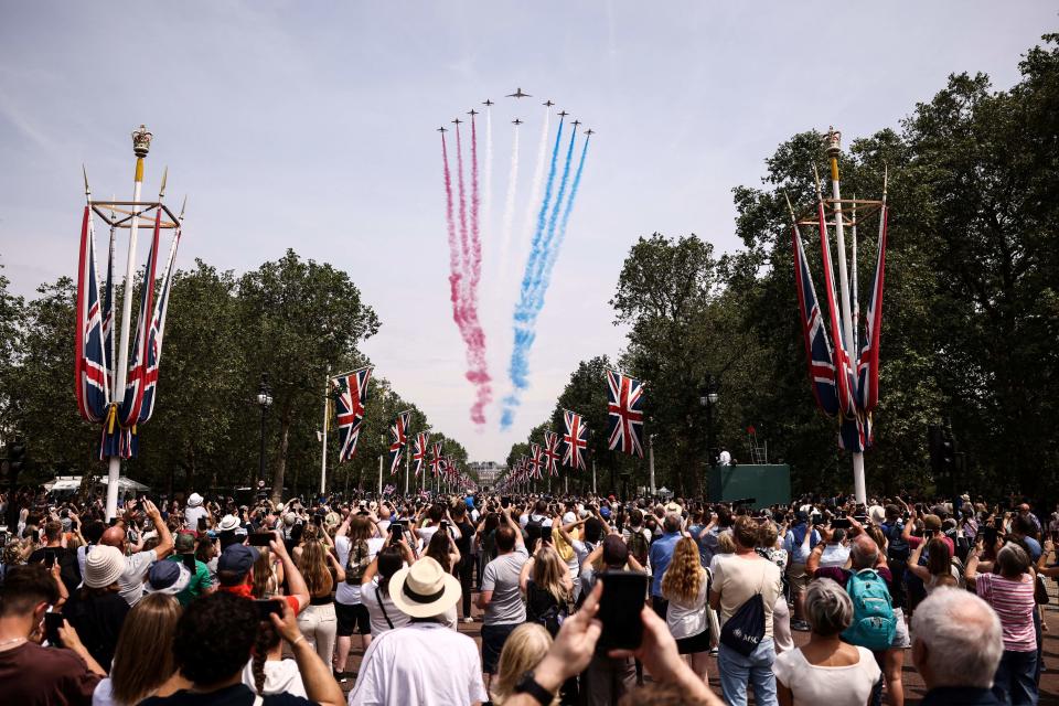 Members of the public cheer as they watch the Royal Air Force Aerobatic Team, the Red Arrows during the King's Birthday Parade, 'Trooping the Colour', in London on June 17, 2023. The ceremony of Trooping the Colour is believed to have first been performed during the reign of King Charles II. Since 1748, the Trooping of the Colour has marked the official birthday of the British Sovereign. Over 1500 parading soldiers and almost 300 horses take part in the event. (Photo by HENRY NICHOLLS / AFP) (Photo by HENRY NICHOLLS/AFP via Getty Images)