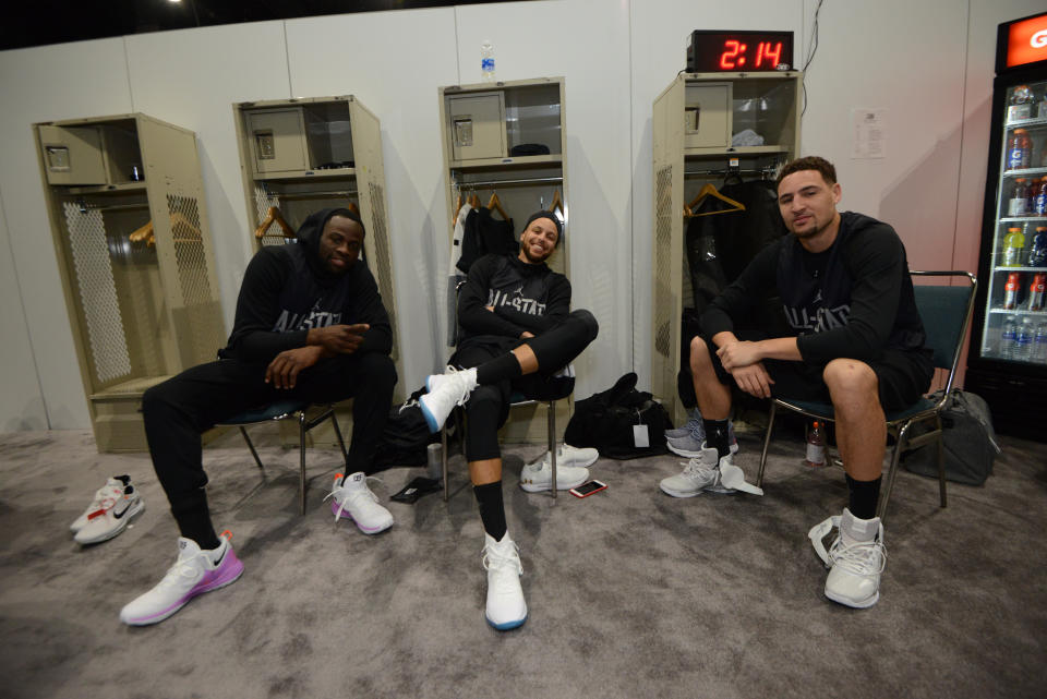 Draymond Green, Steph Curry and Klay Thompson stay loose before All-Star practice Saturday. (Getty)