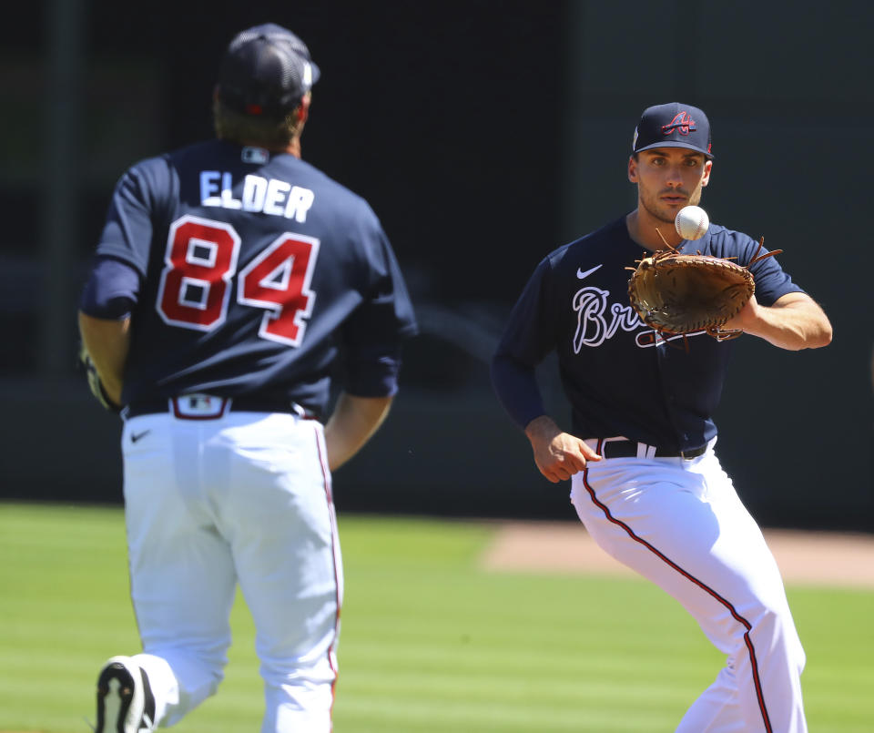 Atlanta Braves starting pitcher Bryce Elder fields a grounder by Minnesota Twins Gilberto Celestino and throw to first baseman Matt Olson for the out during the second inning of a MLB preseason baseball game on Friday, March 18, 2022, in North Port, Fla. (Curtis Compton/Atlanta Journal-Constitution via AP)