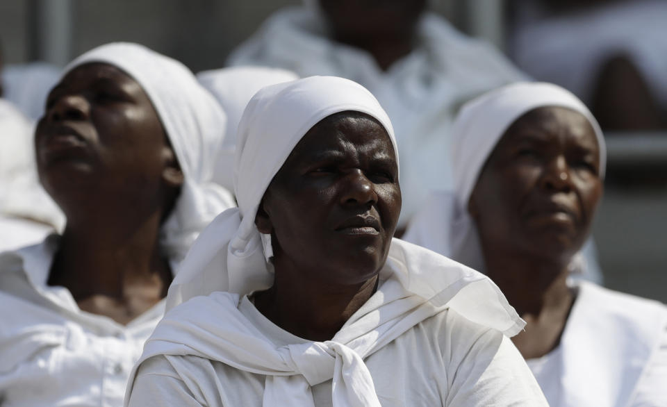 Mourners attend the state funeral service for former President Robert Mugabe at the National Sports Stadium in Harare, Saturday, Sept. 14, 2019. The burial has been delayed for at least a month until a special mausoleum can be built for his remains. (AP Photo/Themba Hadebe)