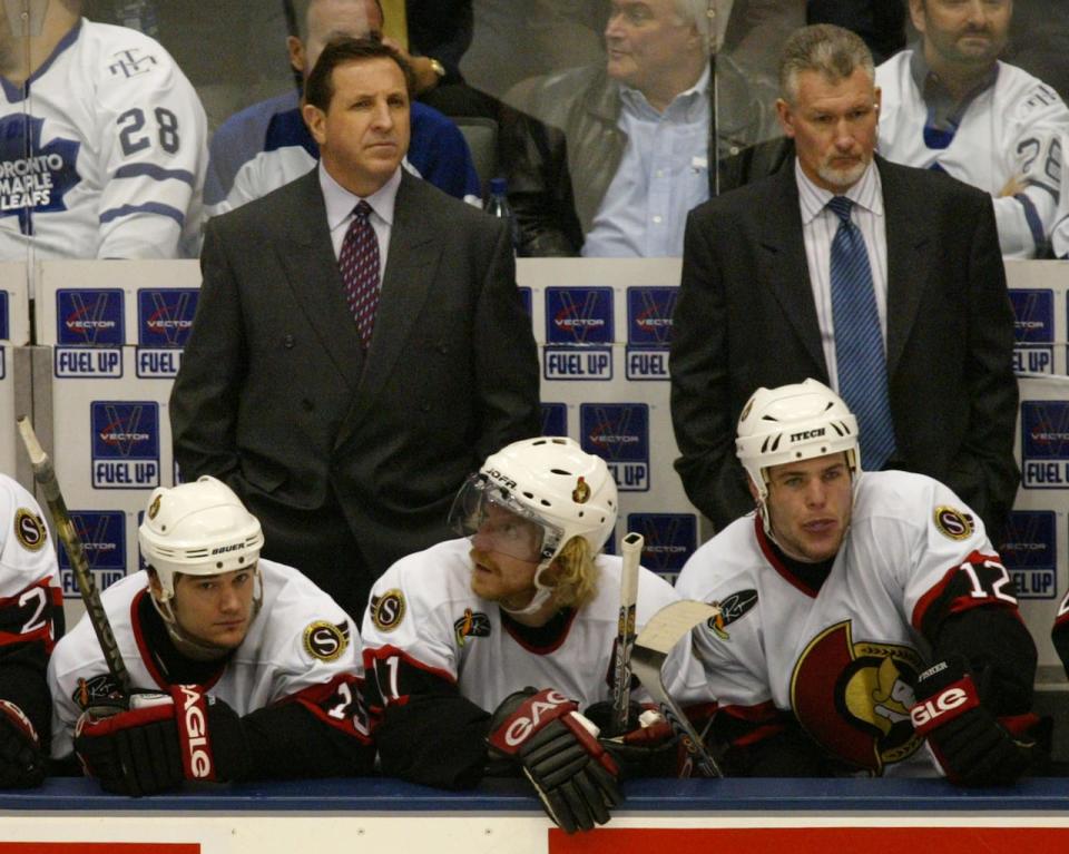 Ottawa Senators head coach Jacques Martin, upper left, behind players Peter Schaefer Daniel Alfredsson and Mike Fisher in the final seconds of their playoff series loss against the Toronto Maple Leafs April 20, 2004.