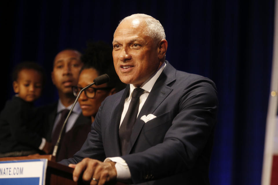 Democrat Mike Espy who sought to unseat appointed U.S. Sen. Cindy Hyde-Smith, R-Miss., and serve the last two years of the six-year term vacated when Republican Thad Cochran retired stands with family members and talks to supporters in a crowded auditorium at the Mississippi Civil Rights Museum in Jackson, Miss., after losing the runoff election, Tuesday night, Nov. 27, 2018. (AP Photo/Charles A. Smith)