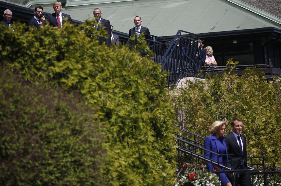 <p>President Donald Trump looks down a hill past France’s President Emmanuel Macron as Macron arrives with his wife Brigitte just ahead of Trump at the G7 Summit in Charlevoix, Quebec, Canada, June 8, 2018. (Photo: Leah Millis/Reuters) </p>