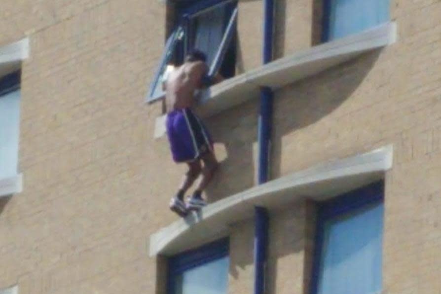 A man seen outside a window of the Holiday Inn hotel