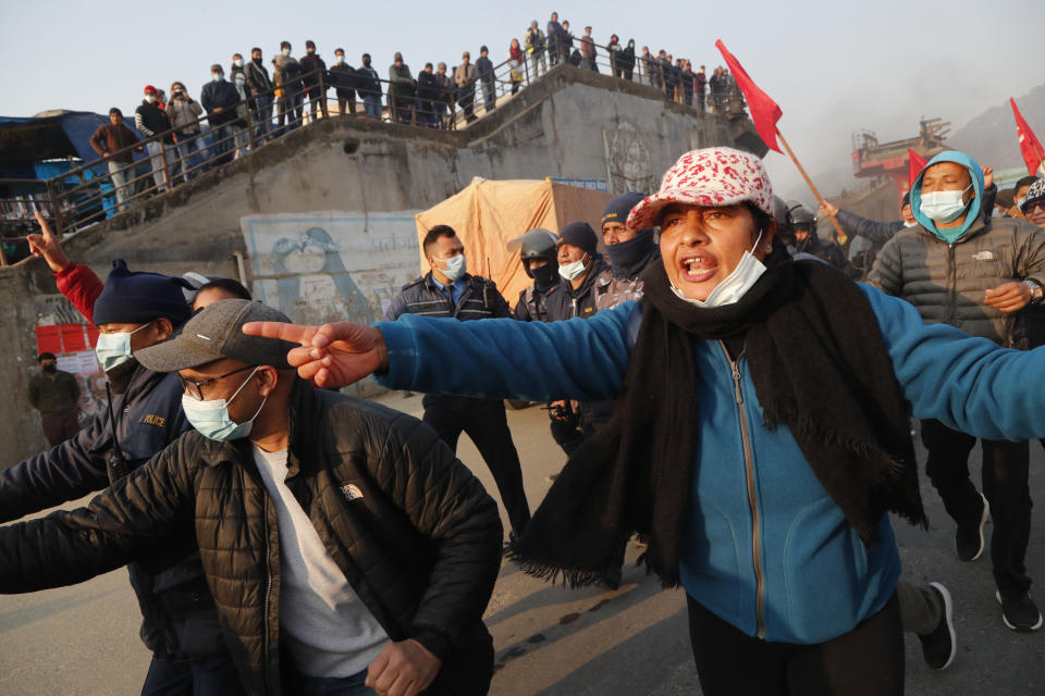 Nepalese demonstrators chant slogans against prime minister Khadga Prassad Oli during general strike in Kathmandu, Nepal, Thursday, Feb. 4, 2021. A general strike called by a splinter faction of the ruling Communist party paralyzed life in Nepal on Thursday, shutting down schools, transportation and markets. Highways were deserted and shops were closed by the strike protesting Prime Minister Khadga Prasad Oli's decision to dissolve Parliament and call new elections. (AP Photo/Niranjan Shrestha)