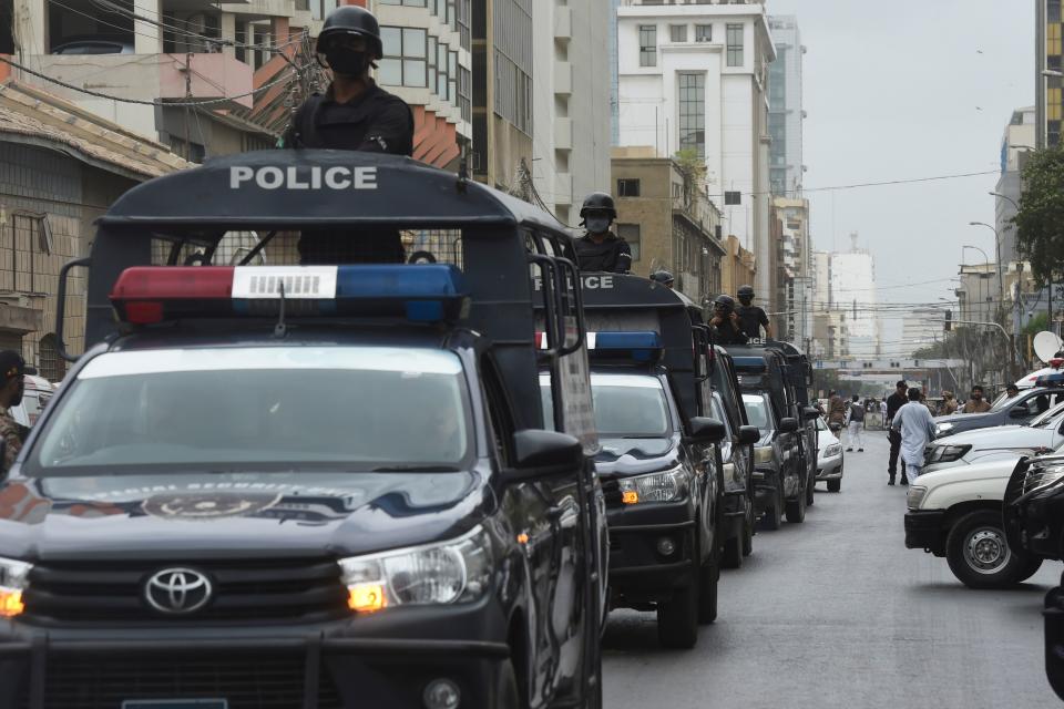 Policemen patrol near the Pakistan Stock Exchange building following an attack by gunmen in Karachi on June 29, 2020. - At least six people were killed when gunmen attacked the Pakistan Stock Exchange in Karachi on June 9, with a policeman among the dead after the assailants opened fire and hurled a grenade at the trading floor, authorities said. (Photo by Asif HASSAN / AFP) (Photo by ASIF HASSAN/AFP via Getty Images)