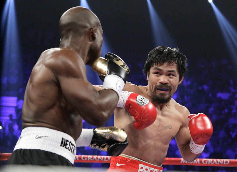 Manny Pacquiao, right, from the Philippines, and Timothy Bradley, from Palm Springs, Calif., work in the first round of their WBO welterweight title fight Saturday, June 9, 2012, in Las Vegas.