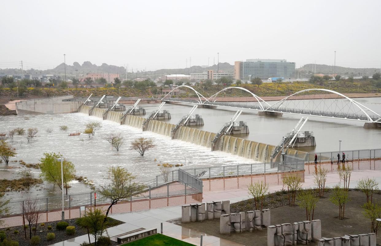 Flood water spills over Tempe Town Lake Dam due to the Salt River flooding as dams northeast of Phoenix release snowmelt runoff on March 15, 2023.