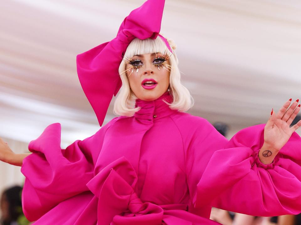 lady gaga attends the met gala in 2019 wearing pink ballgown and headpiece