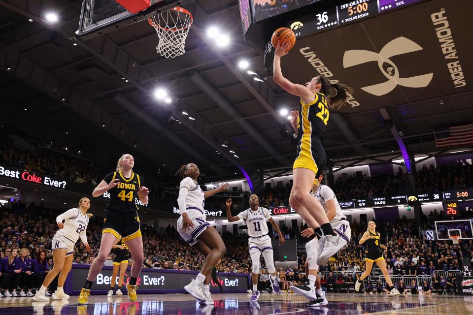 Caitlin Clark #22 of the Iowa Hawkeyes scores her 3,403 career point, passing Kelsey Mitchell for second in Division I NCAA women's basketball history, during the second quarter against the Northwestern Wildcats at Welsh-Ryan Arena on January 31, 2024 in Evanston, Illinois.