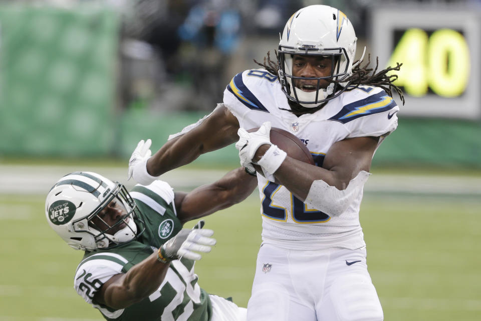 FILE - In this Sunday, Dec. 24, 2017 file photo, Los Angeles Chargers running back Melvin Gordon (28) breaks a tackle by New York Jets' Marcus Maye (26) during the second half of an NFL football game in East Rutherford, N.J.  Melvin Gordon got better as last season went on for the Los Angeles Chargers because he got healthier. The durable running back subsequently structured his offseason around staying fresh for another playoff chase, and he's already in top form in training camp. (AP Photo/Seth Wenig, File)