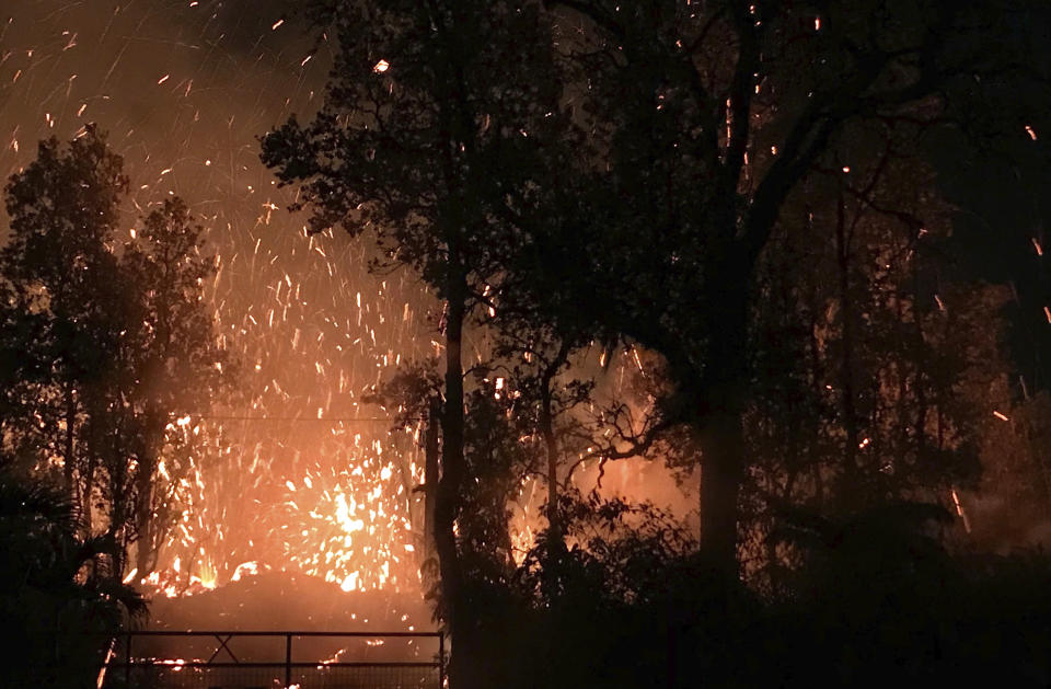 The eruption sent molten lava through forests and bubbling up from paved streets. Source:Shane Turpin/seeLava.com via AP