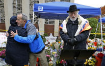 A Shabbat morning service led by former Tree of Life rabbi Chuck Diamond,center, is held outside the Tree of Life Synagogue Saturday, Nov. 3, 2018 in Pittsburgh. About 100 people gathered in a cold drizzle for what was called a "healing service" outside the synagogue that was the scene of a mass shooting a week ago. (AP Photo/Gene J. Puskar)