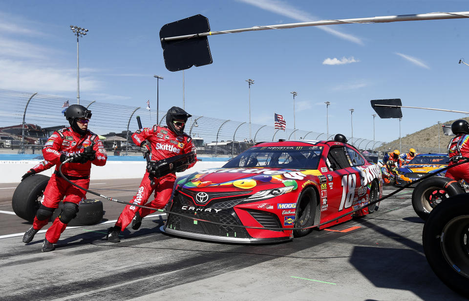 Driver Kyle Busch makes a pit stop on lap 153 during the NASCAR Cup Series auto race at ISM Raceway, Sunday, March 10, 2019, in Avondale, Ariz. (AP Photo/Ralph Freso)