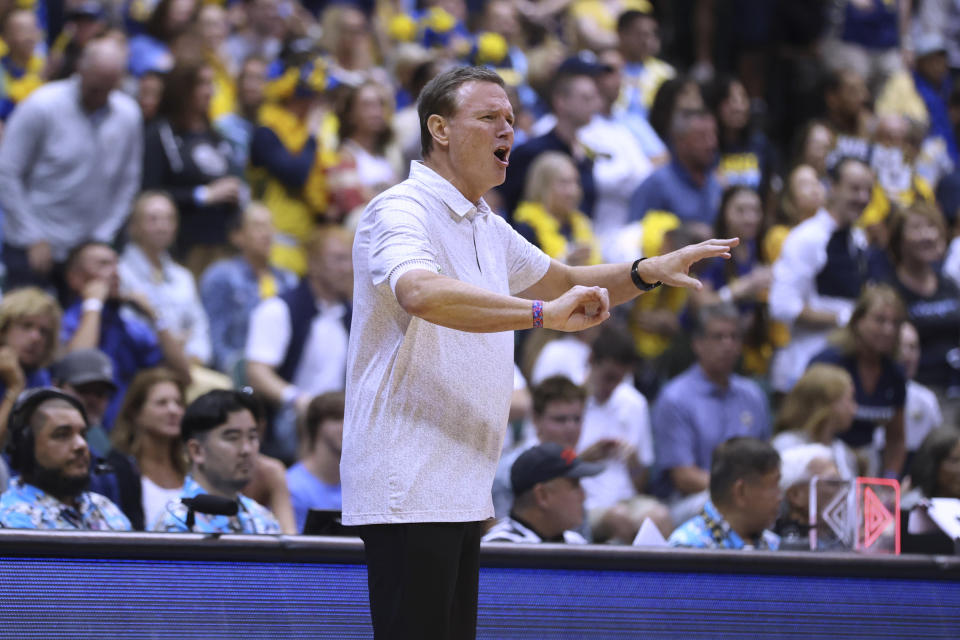 Kansas coach Bill Self watches the team play against Marquette during the first half of an NCAA college basketball game Tuesday, Nov. 21, 2023, in Honolulu. (AP Photo/Marco Garcia)