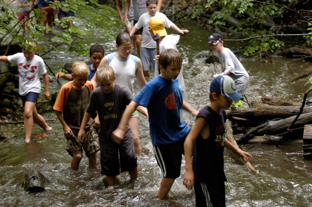 Local students trek through Juday Creek at Izaak Walton League in South Bend in 2006 during Camp Awareness, which continues today through the city's Venues, Parks & Arts department. JANAR STEWART, SOUTH BEND TRIBUNE