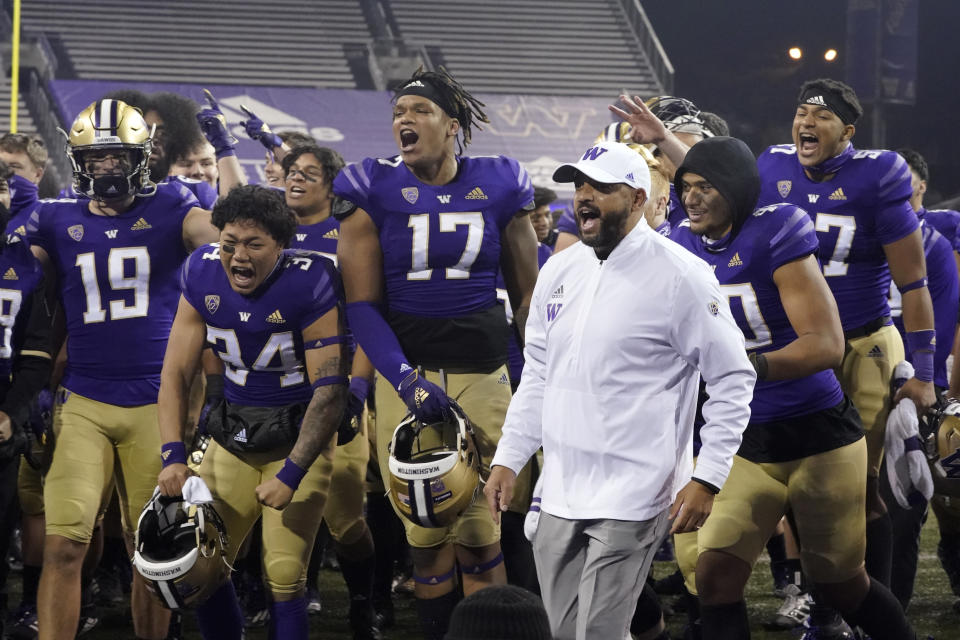 Washington coach Jimmy Lake celebrates with the team after Washington defeated Utah 24-21 in an NCAA college football game Saturday, Nov. 28, 2020, in Seattle. (AP Photo/Ted S. Warren)