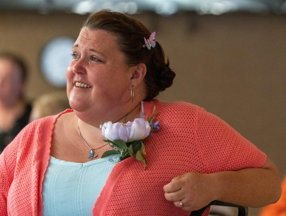 Tasheena Duncan, administrator at Summerfield Health Care Center, Cloverdale, Ind., Saturday, May 21, 2022, watches the wedding of Sara Smouther and Matt Weeks.