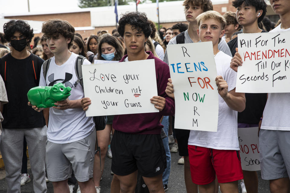 Kids hold up signs protesting gun violence