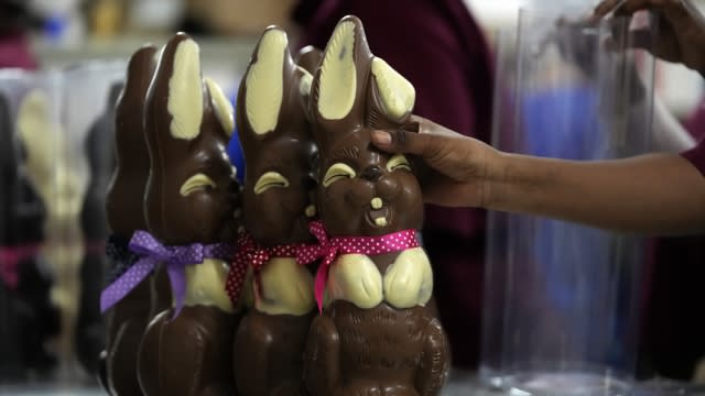 An employee picks up a chocolate Easter bunny